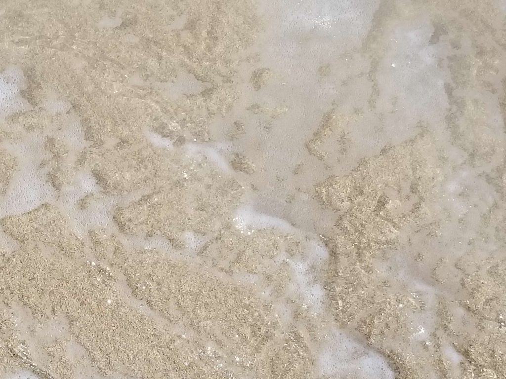 Close up picture of sand and water