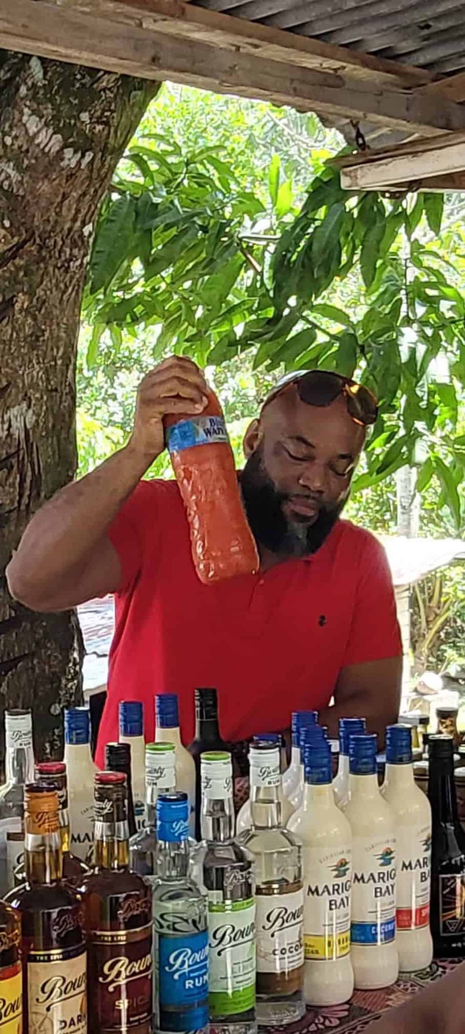 Our guide getting a bottle of homemade rum punch for the group