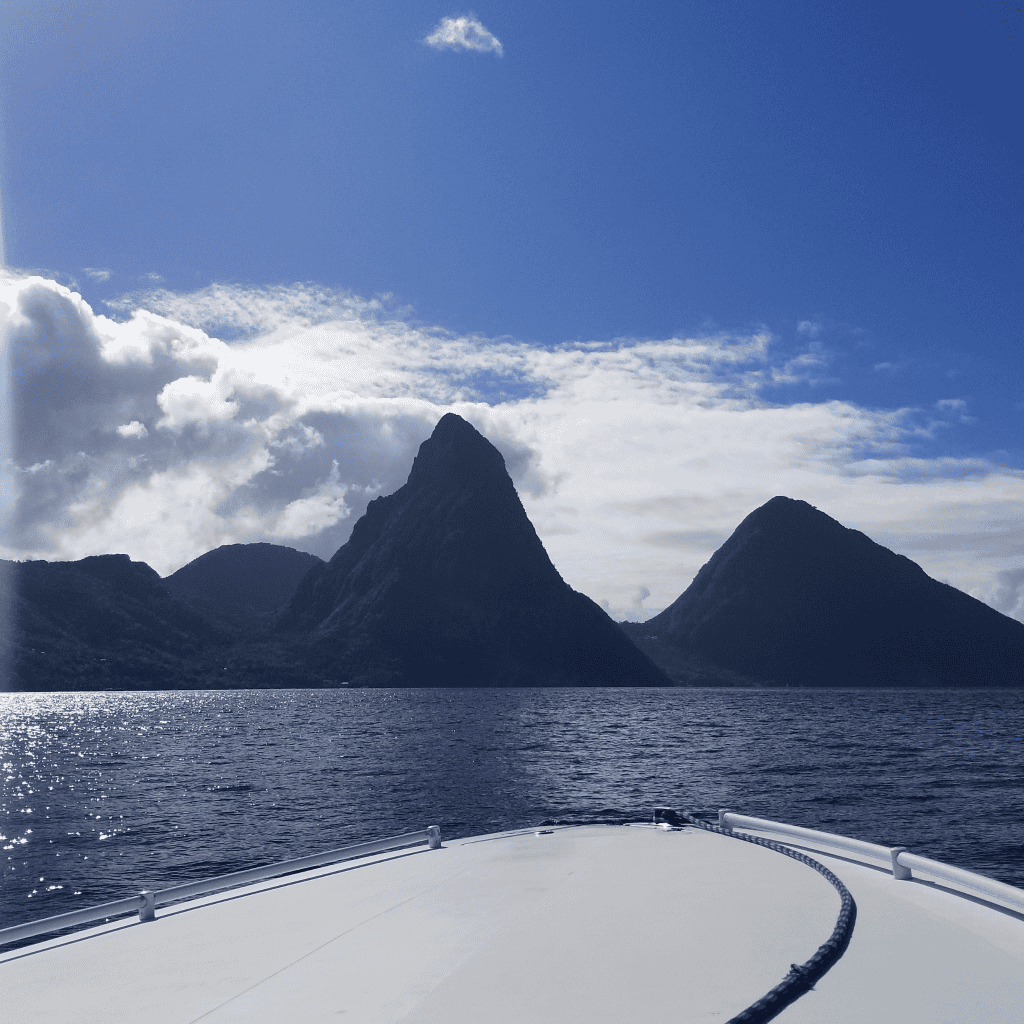 The Mountains in St. Lucia with the front of a speed boat