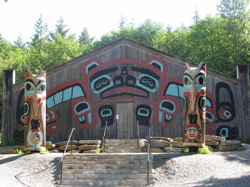 Totem Poles in front of a Tribal Building