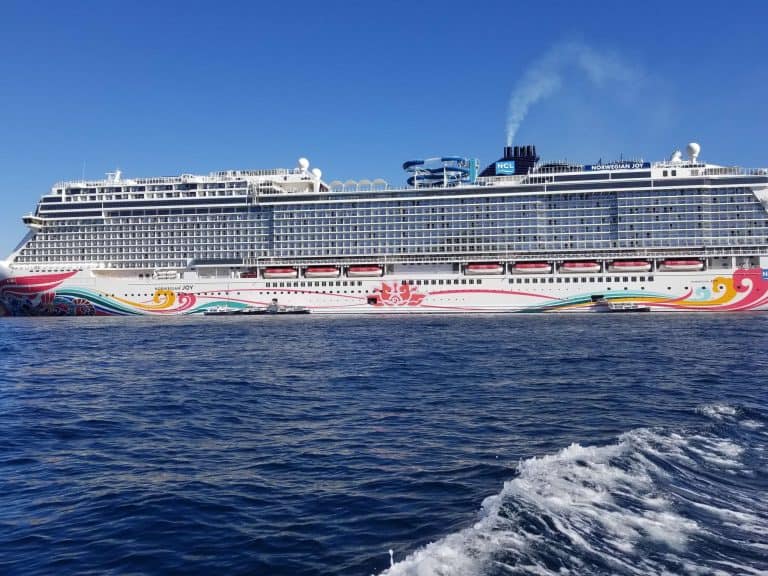 NCL Cruise ship anchored in the ocean near cabo san lucas with tender boats on its side