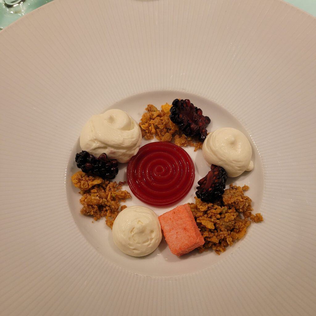 Breakfast plate with granola, yogurt and fruit displayed neatly