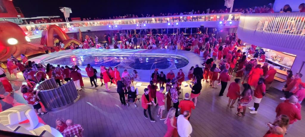 Scarlet night at the pool on Virgin Voyages cruise