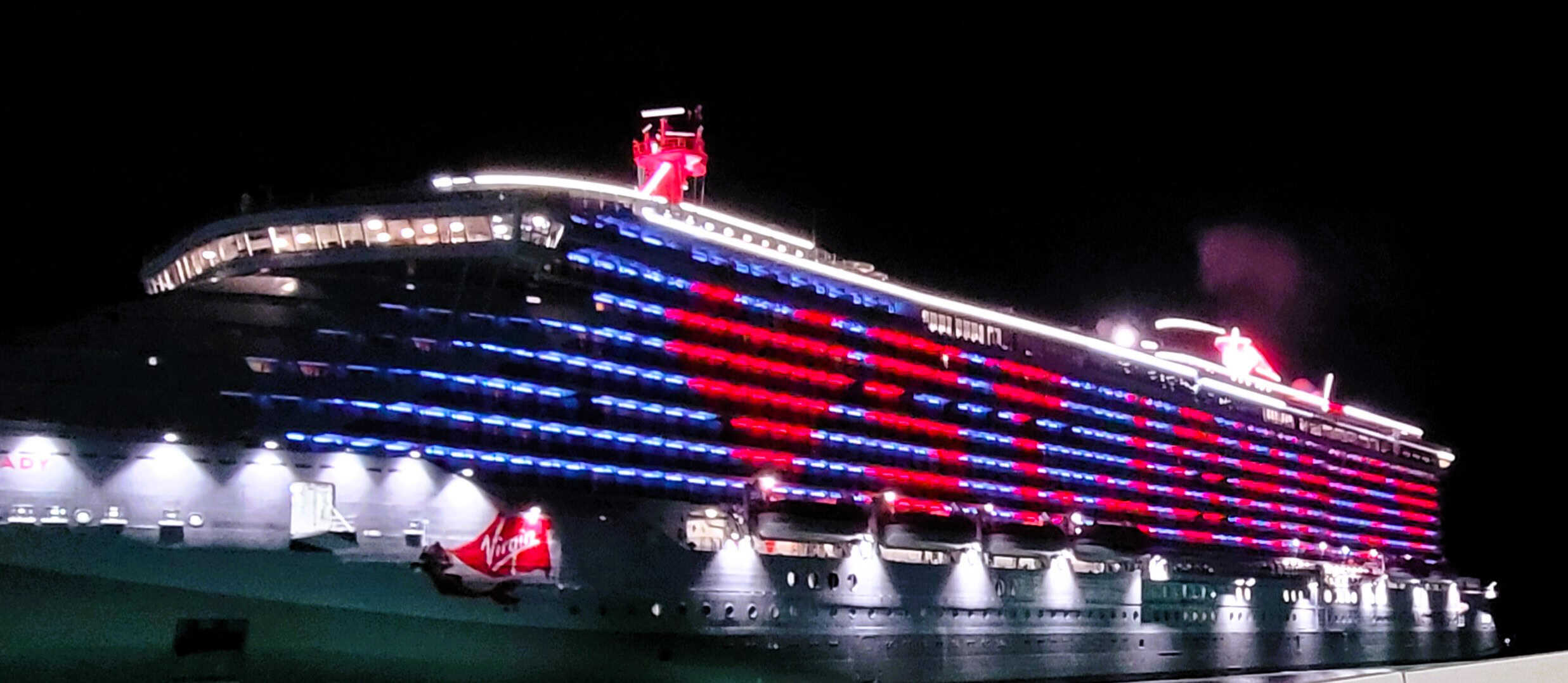 A large cruise ship lit up at night