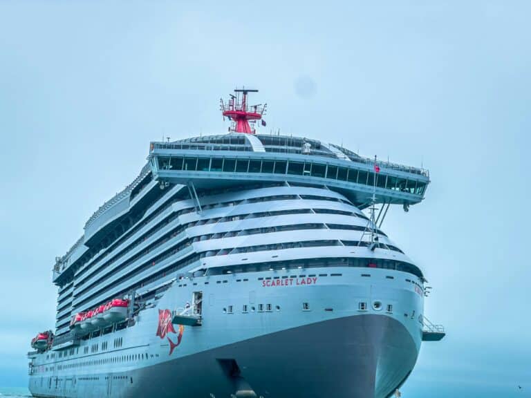Virgin Voyages Scarlet Lady docked in port before an adults-only cruise.