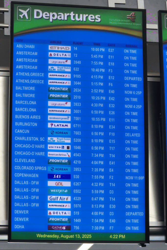 Airport departure board showing international flights to European cities, part of planning flights for a cruise.