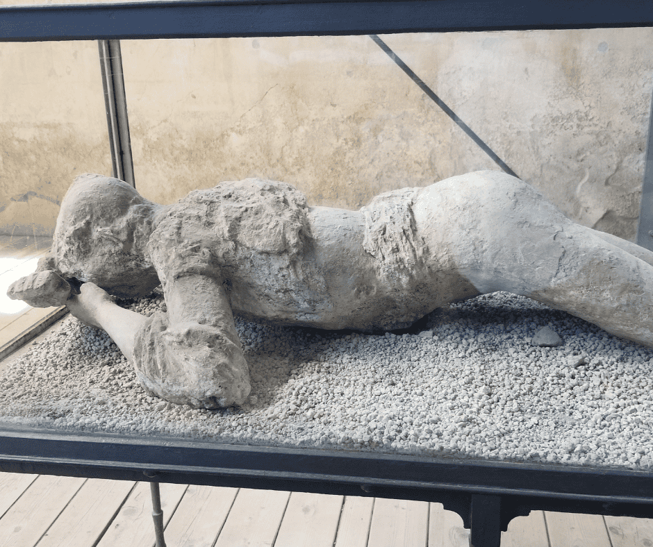 Preserved body cast from Pompeii ruins, part of a day trip combining Pompeii, Herculaneum, and an Italian winery lunch on a European cruise excursion.