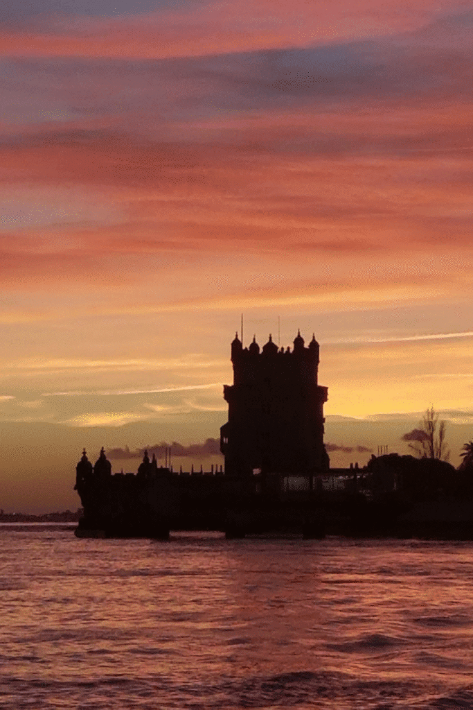 Castle silhouette at sunset on the European coast — a dreamy start to European cruise preparations.