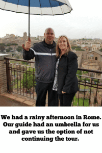 Couple touring Rome in the rain with a private guide holding an umbrella, showing the importance of compatible travel companions on a European cruise trip.