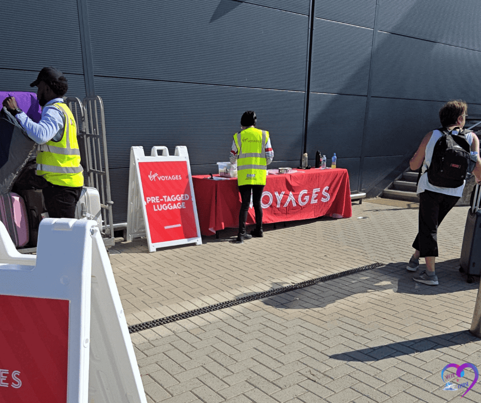 Travelers checking pre-tagged luggage at Virgin Voyages cruise terminal