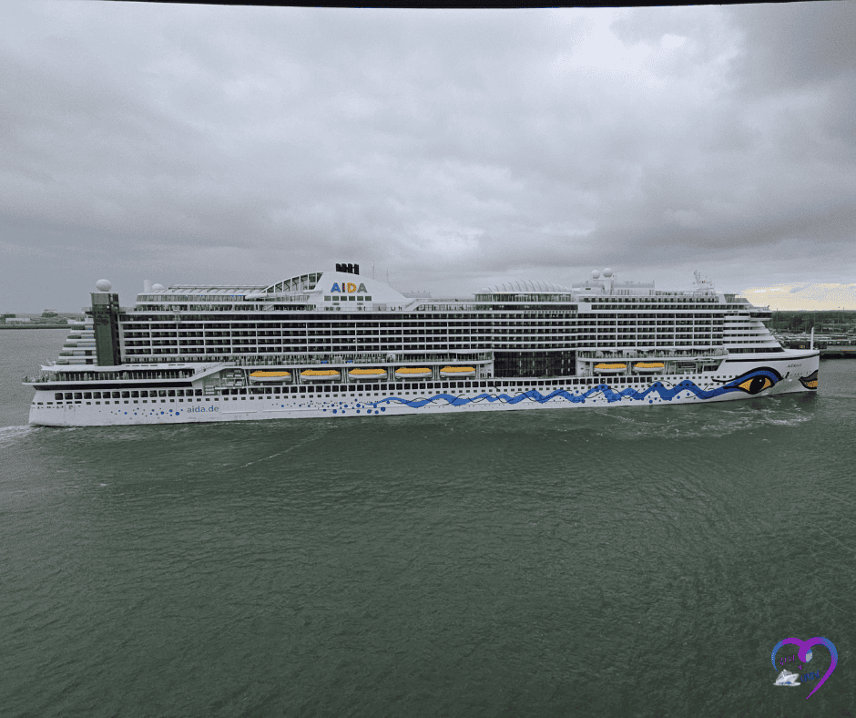 Cruise ship leaving port under cloudy skies, signaling it’s time to set sail.