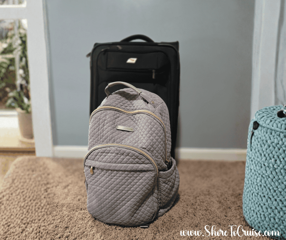 Carry-on suitcase and backpack packed for a British Isles cruise with neutral capsule wardrobe