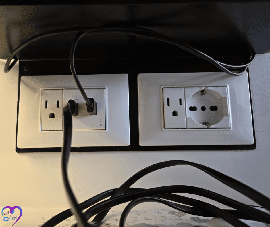 Multiple outlet types with cables plugged in, showing need for adapters when traveling in Europe.