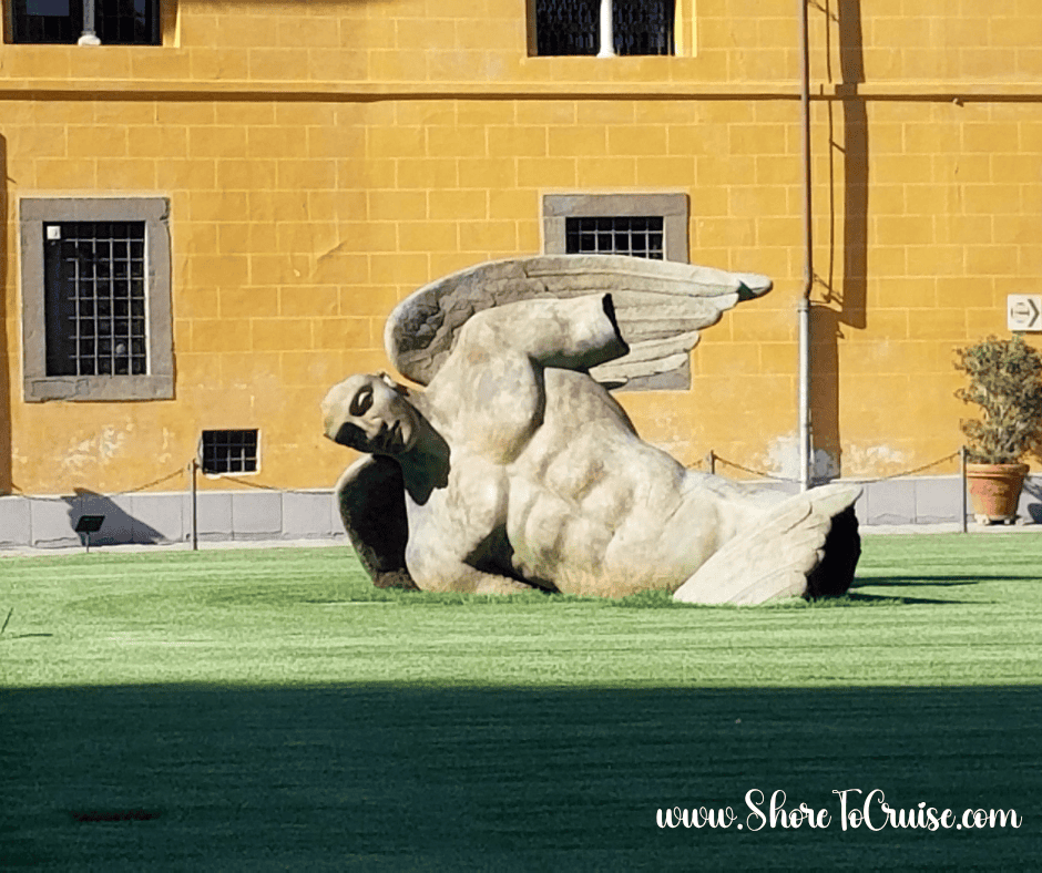 Reclining marble statue in Italy — playful reminder to relax, pack light, and skip the unnecessary items.