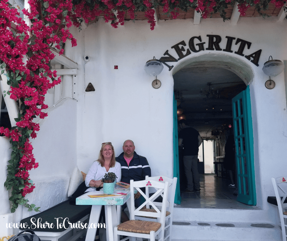 Bougainvillea-covered taverna in Mykonos, Greece — breezy and colorful inspiration for Mediterranean cruise fashion.